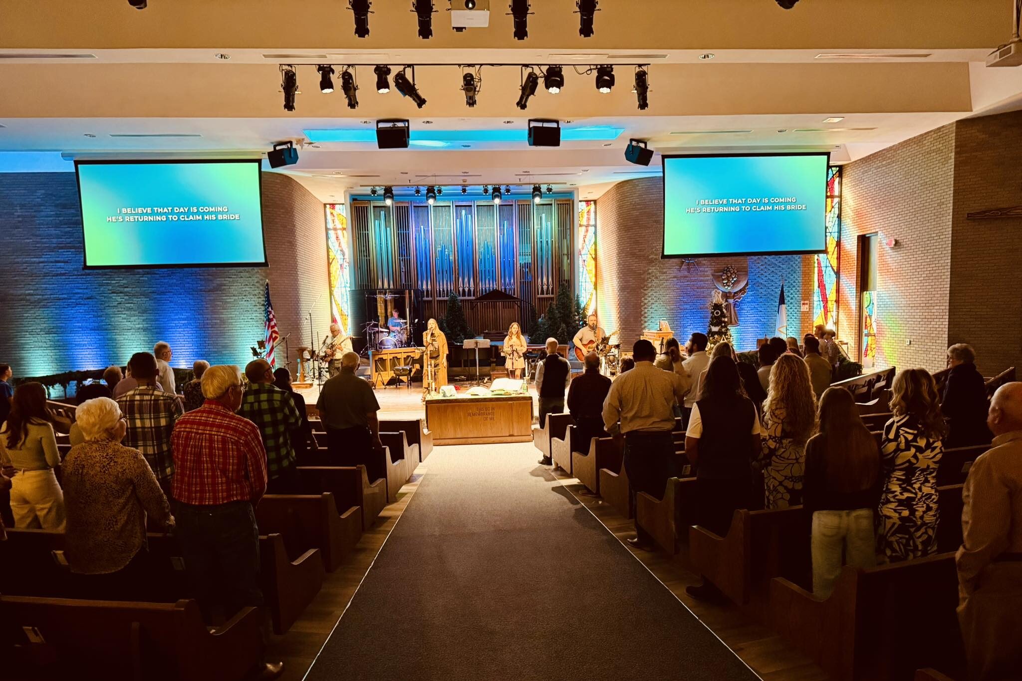 589036116_1371867098057897_5541084863823883442_n girl's left hand wrap around toddler while reading book during golden hour